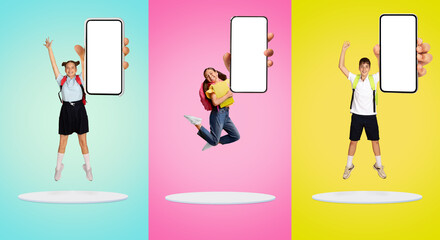 Three schoolchildren in uniform joyfully jumping with blank smartphone in hand