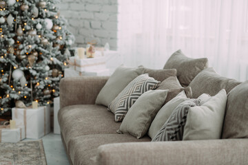 A cozy indoor setting with a couch adorned with pillows, and a Christmas tree in the background 5473.