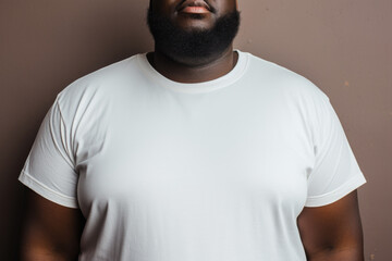 Cropped view of a man in a white t-shirt, focused on body positivity.