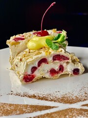 Winter cherry dessert. A beautiful dessert. Meringue roll. Dessert with cherries