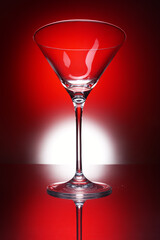 Empty martini glass on red background