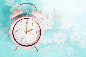 Alarm clock with cherry blossoms, switch to daylight saving time in spring, summer time changeover
