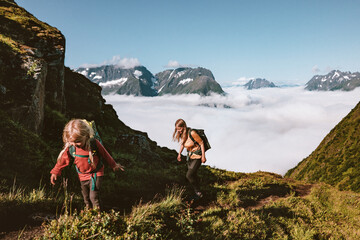 Child and mother family hiking in mountains of Norway, active healthy lifestyle adventure tour...