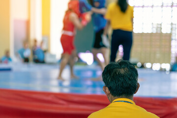 Back view of Judges work during Wushu Boxing Cup among young women, juniors and girls. The referee...