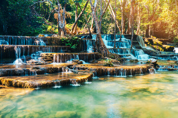 Beautiful of Huai mae khamin waterfall Srinakarin national park at Kanchanaburi thailand. Waterfall clear emerald water on autumn and summer season with rock for holiday relax on green tree in jungle.