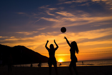 Silhouettes of beautiful women playing volleyball at sunset on the beach.