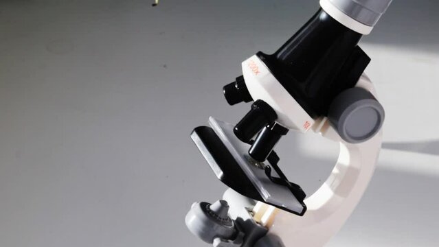 Close up, slow motion footage of the microscope on the window. Science