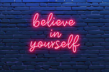 Neon sign with text believe in yourself on brick wall, motivational and inspirational quotes