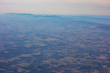 Rural Virginia with the Blue Ridge Mountains in the background, seen from high above through a plane window.