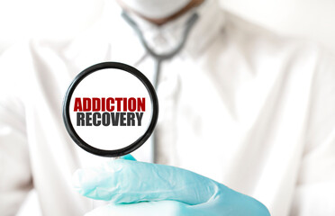 Doctor holding a stethoscope with text ADDICTION RECOVERY, medical concept