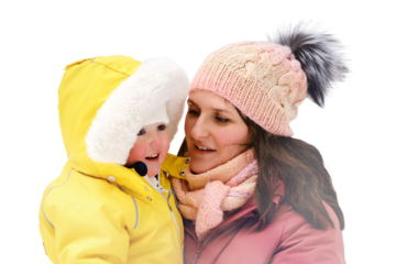 A mother woman holds a toddler baby in her arms, winter snow, isolated on white background. Mom and son boy in warm clothes on the background of snowy nature. Kid aged one year eight months