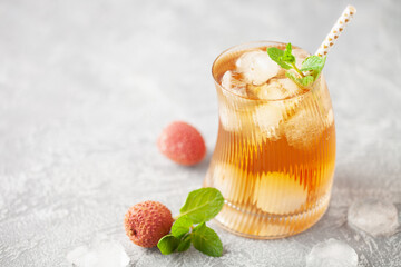 Lychee iced tea with mint leaves in drinking glass. Refreshment drink