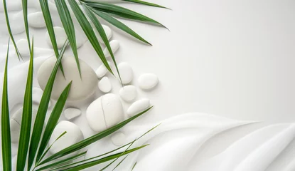 Foto auf Acrylglas Top view of natural white stones and palm leaf  on white sand, beautiful sandy texture. Spa background. Summer tropical background for luxury product placement.  © Viks_jin