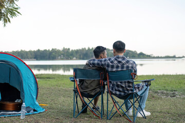 Happy Asian male gay couple on camping together in a forest. romantic vocation trip. lgbt concept