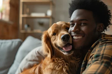 Poster Young adult black man with his golden retriever dog in a living room © Dantaz