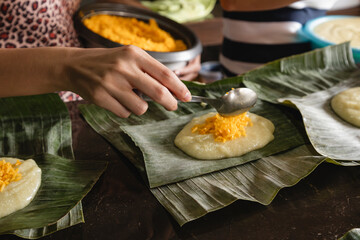 Unrecognizable person preparing tamales