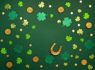 Golden Horseshoe, Gold Coins and Clover Leaves Shamrocks on Green Background for St Patricks Day...