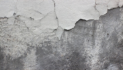 Fototapeta premium Close-up of a weathered aged, cracked concrete wall texture with peeling white paint and concrete revealing the textured surface beneath.