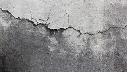 Close-up of a weathered aged, cracked concrete wall texture with peeling white paint and concrete revealing the textured surface beneath.