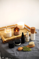 Fototapeta na wymiar Candles and skincare products on table