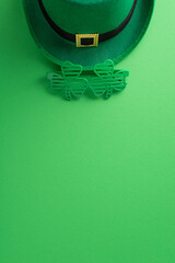St. Paddy's charm in one shot: vertical top view of leprechaun's hat, and themed party glasses on a...