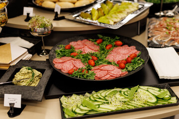 A photo of a buffet table with various dishes and platters of food