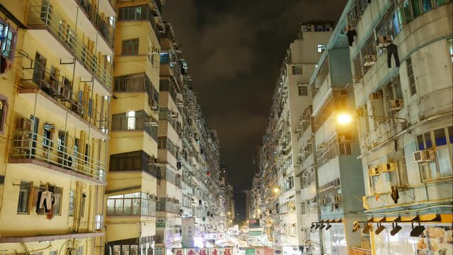 Time lapse of apartment buildings and night market in Hong Kong