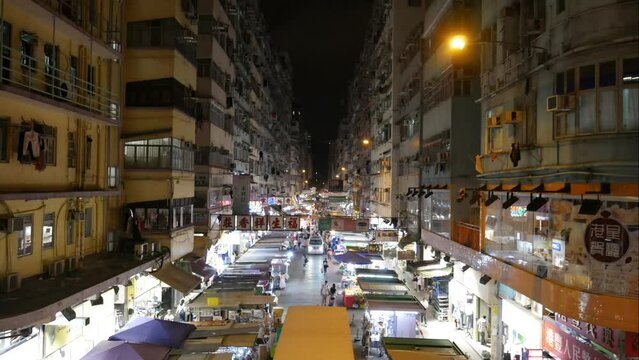 Time lapse of apartment buildings and night market in Hong Kong