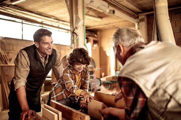 Grandfather, Father, and Son in a Woodworking Workshop