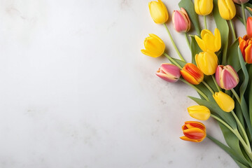 Bouquet of fresh colorful tulips on a marble background. Copy space, flat lay. Festive background