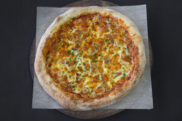 Hot pizza with mozzarella cheese and green basil close-up