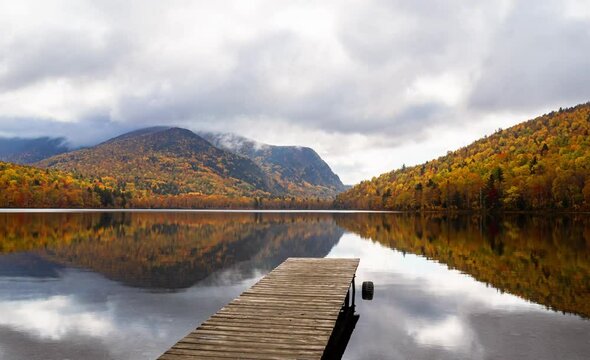 Autumnal Serenity: Cloud Timelapse over Baxter Pond with Vibrant Fall Foliage