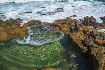 A beach at La Perla village, Old San Juan, Puerto Rico. Wave is coming and hitting to a rock, a natural phenomenon of the Earth movement. Good for background ideas or ecological, environmental subject