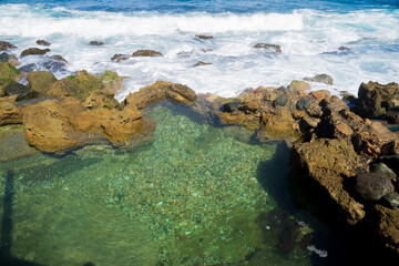 A beach at La Perla village, Old San Juan, Puerto Rico. Wave is coming and hitting to a rock, a natural phenomenon of the Earth movement. Good for background ideas or ecological, environmental subject