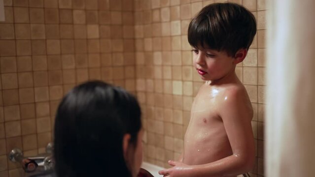 Bath time Bonding - Mother Gently Applying Soap to Child's Body as Part of Nighttime Parenting Routine