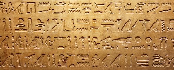 Old Egyptian hieroglyphs on an ancient background. Wide historical and culture background. Ancient Egyptian hieroglyphs as a symbol of the history of the Earth. - obrazy, fototapety, plakaty