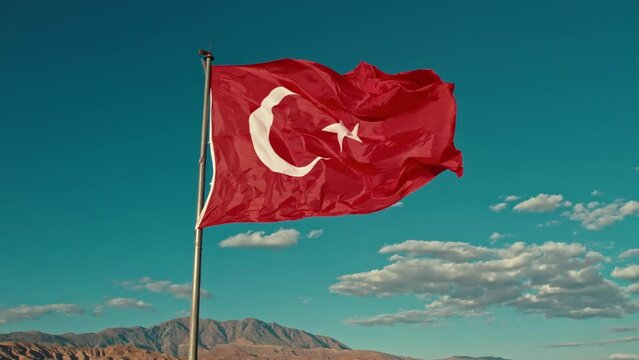 In this compelling video content, A majestic representation of the Turkish flag proudly standing at the summit, gracefully swaying in the wind, symbolizing the freedom in the sky. 