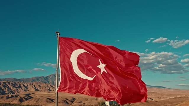 In this compelling video content, A majestic representation of the Turkish flag proudly standing at the summit, gracefully swaying in the wind, symbolizing the freedom in the sky. 