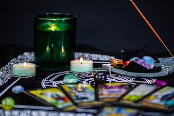 candles and tarot cards on the mat with ornaments 