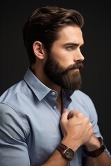 cropped shot of a handsome young businessman looking away with his hand in his beard