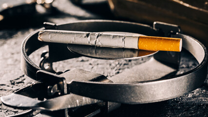 A conceptual view of smoking, represented by a cigarette as a bait in a trap.