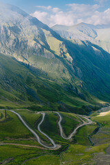 Mountain pass in Georgia in summer. Views from one of the most dangerous road on the world in Georgia. Road to Omalo.  Abano pass in the Caucasus mountains. Top view of winding road. - obrazy, fototapety, plakaty