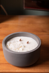 Handmade peonies scented candles in ceramic bowl with wooden wick and unusual design. Soy wax candles with wooden wick.