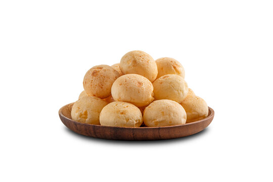 Cheese Breads pile on wooden plate. Brazilian snack. Isolated on white background.