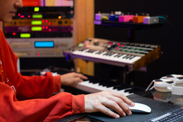 asian professional music producer, composer, arranger, songwriter arranging a hit song on computer in home recording studio. music production concept - obrazy, fototapety, plakaty