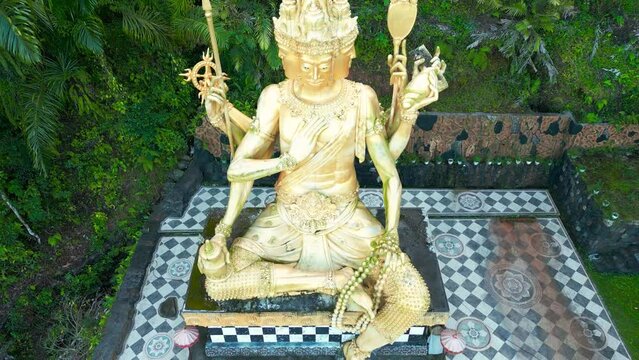Aerial view on Gold Brahma God Statue on Jungle Desa Duda in Bali. Discover the Rich Hinduism Heritage of Asia's Vacation Destination in Indonesia.