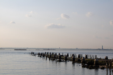 a wooden pier sitting near the ocean under a cloudy sky