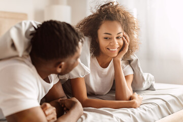 Obraz na płótnie Canvas Loving Black Spouses Smiling Enjoying Romantic Morning In Bedroom