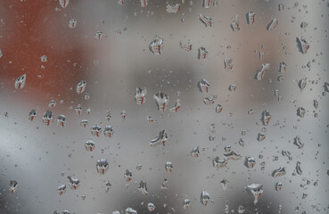 Raindrops on the window glass.