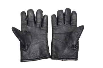 Old black leather warm gloves on a white background.